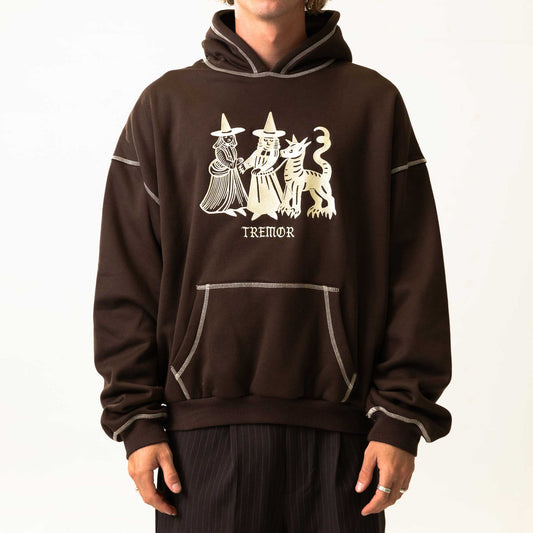 Brown hoodie with white graphic design and 'Tremor' text on a plain background