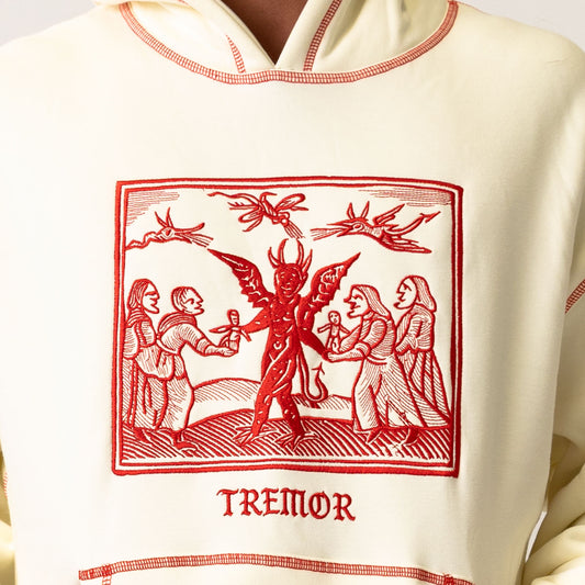 White hoodie with red graphic design and 'Tremor' text on a white background